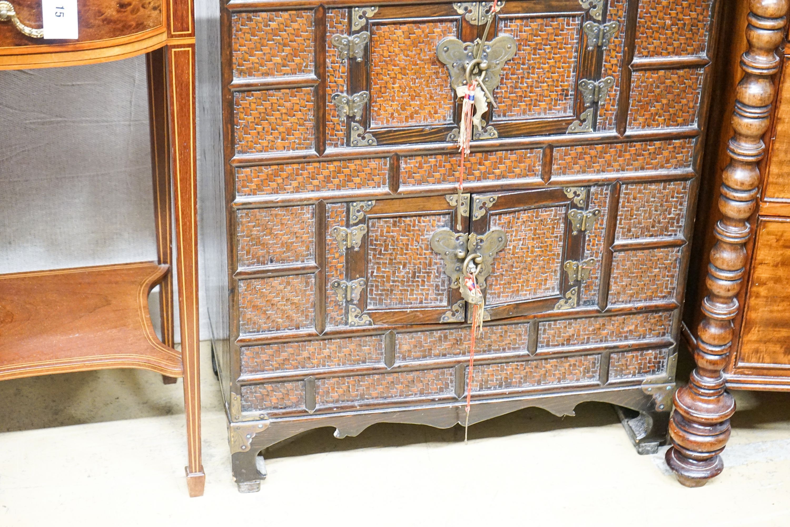 A 20th century Chinese stained wood and rattan side cabinet, width 67cm, depth 32cm, height 104cm